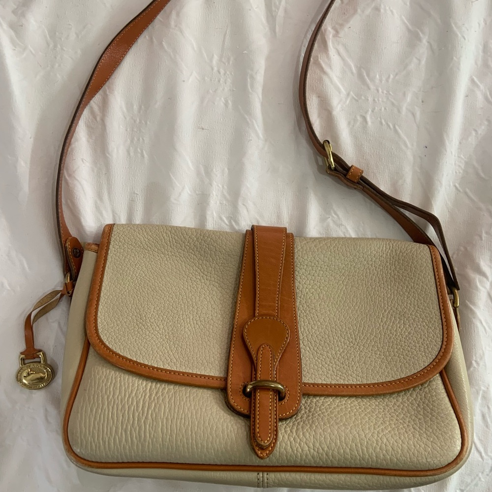 Elegant Dooney and Bourke weather leather Cream and Tan Leather Shoulder Bag